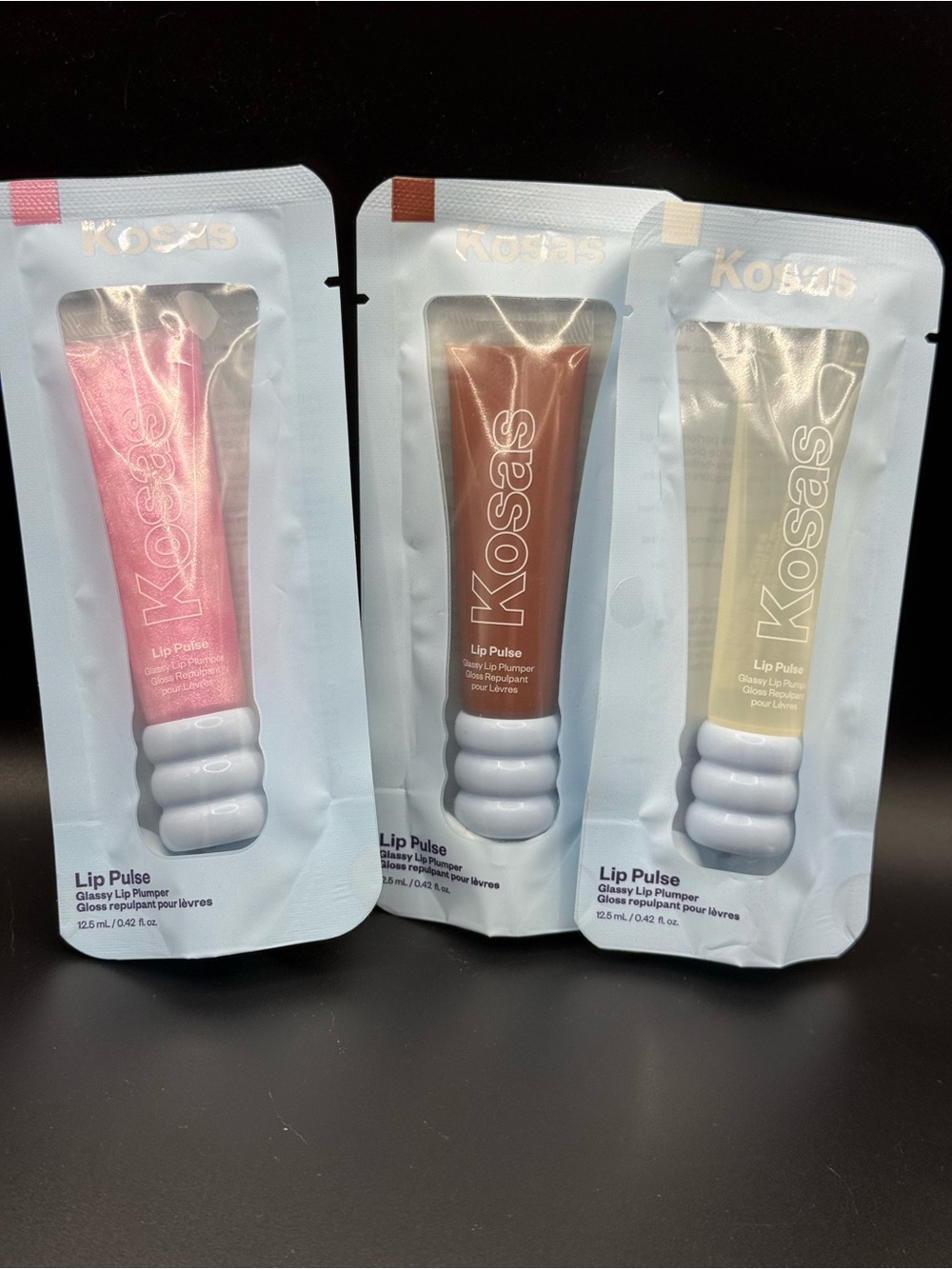 Kosas Lip Pulse Gloss Trio — clear, pink shimmer, and warm beige